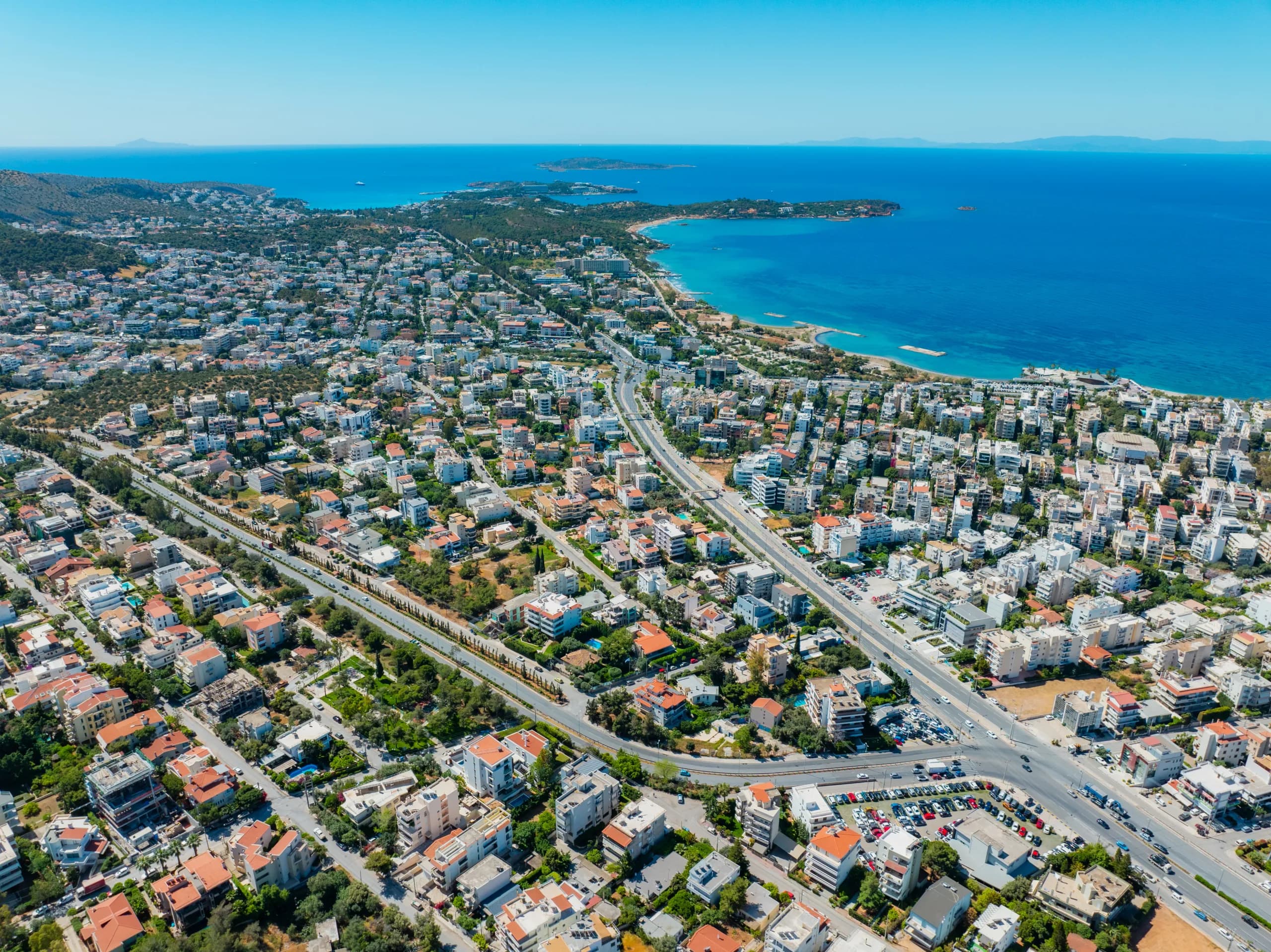 Aerial view of a coastline with a marina and open sea