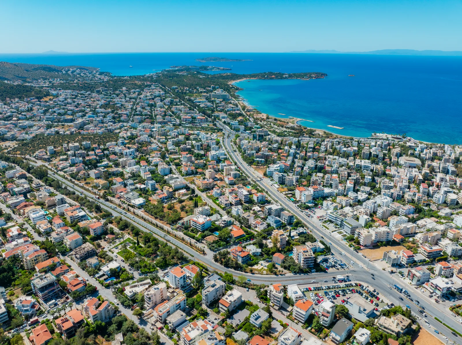 Aerial view of a coastal town stretching along the sea