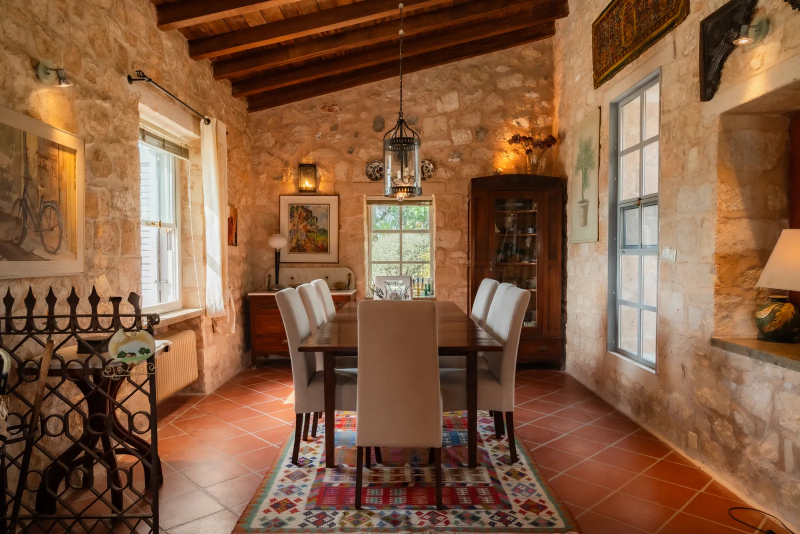 Traditional dining room with a beamed wooden ceiling and stone walls